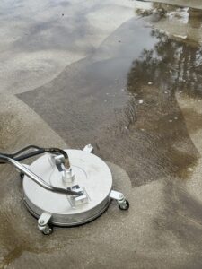 Surface cleaner in action, thoroughly removing dirt and grime from concrete, leaving a clean, even finish.